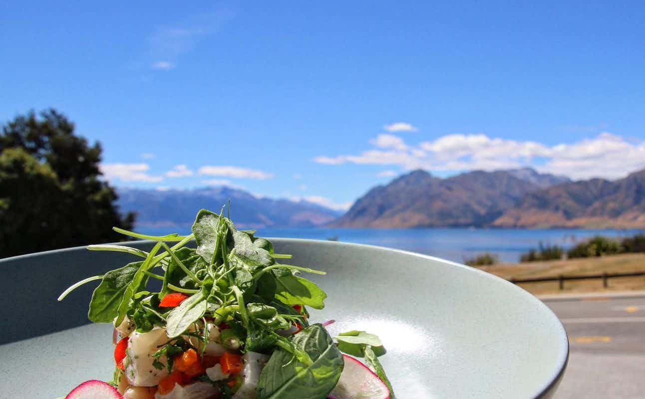 Enjoy New Zealand, Gluten Free Options, Vegetarian options, Hotel Restaurant, Late night, Indoor & Outdoor Seating, Wheelchair accessible, Highchairs available, Table service, Waterfront, Free Wifi, $$, Groups, Families and Live music cuisine at Hawea Hotel Lakeside Bistro in Lake Hawea, Wanaka